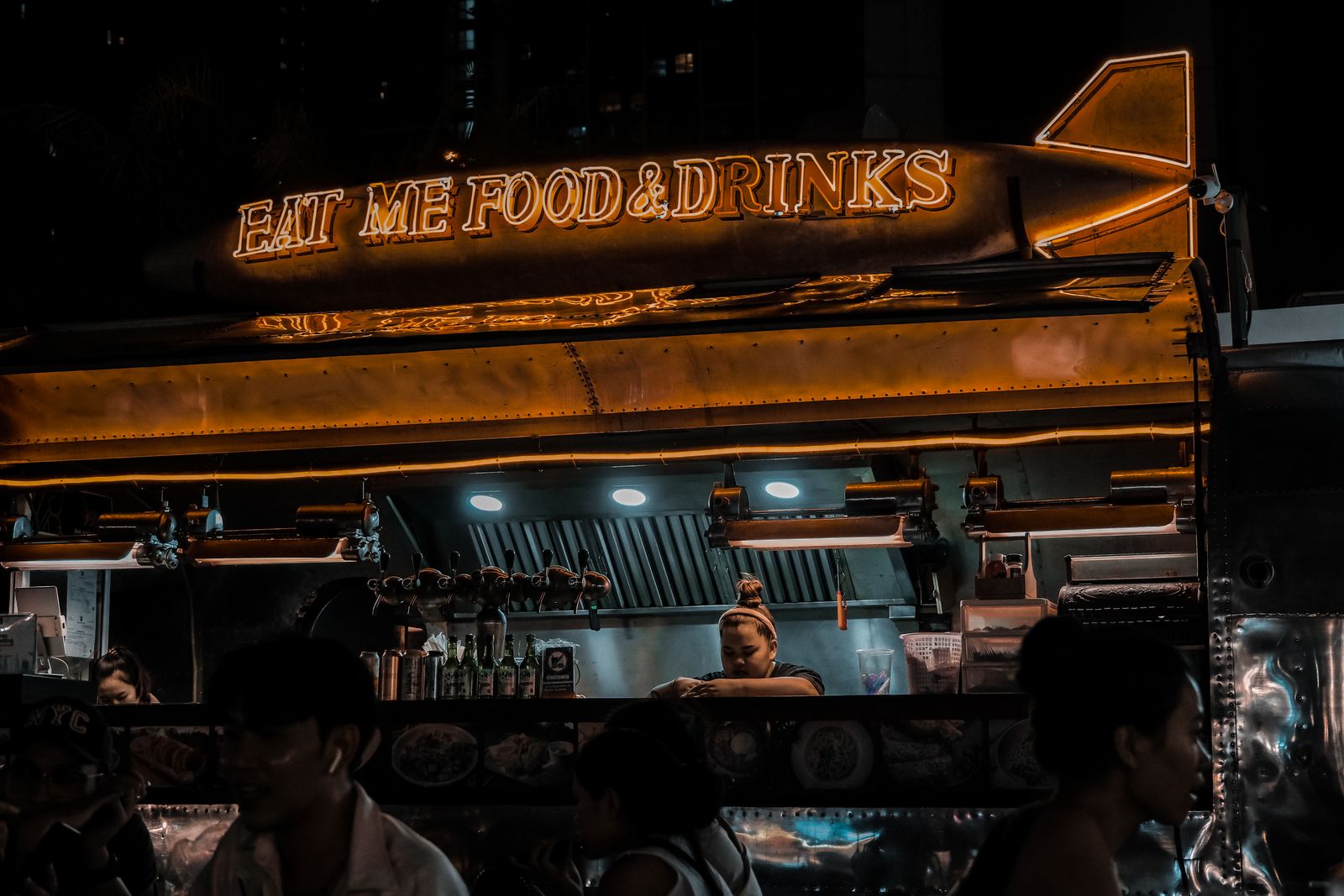 Illuminated food truck serving customers after dark
