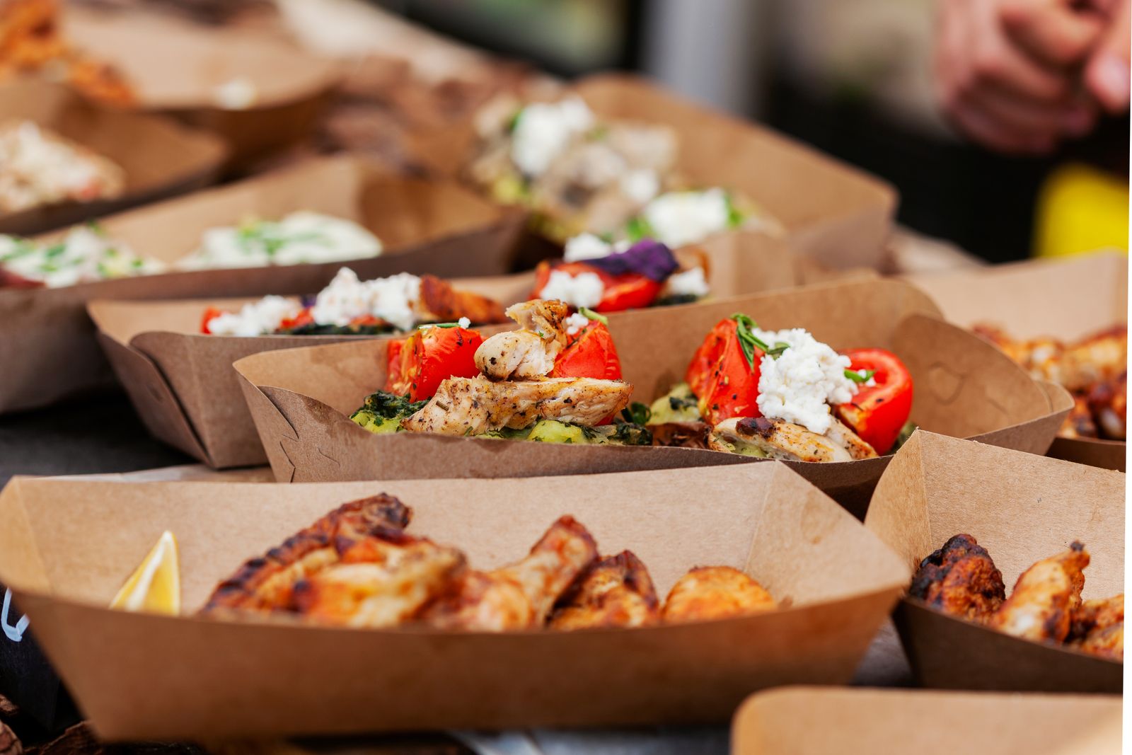 Street food trays of grilled chicken, feta and wings